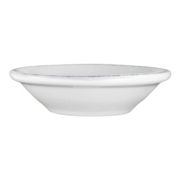 A white porcelain fruit bowl with a blue sponged rim.