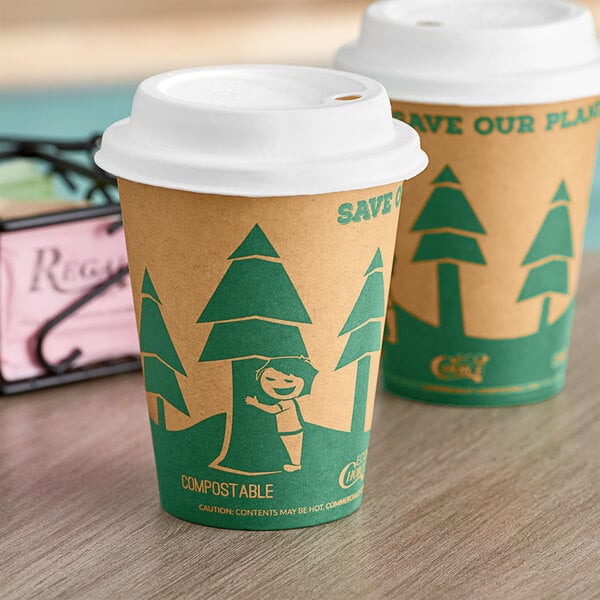 Two EcoChoice Kraft paper cups with tree print and a sugarcane lid on a table.
