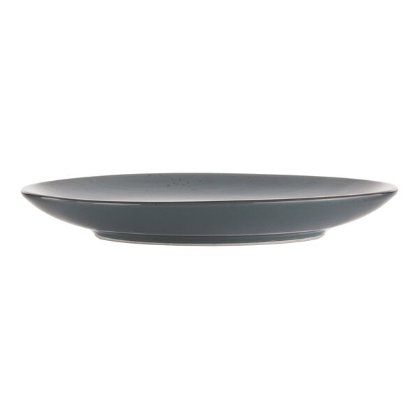 A dark grey International Tableware stoneware coupe plate with a rim.