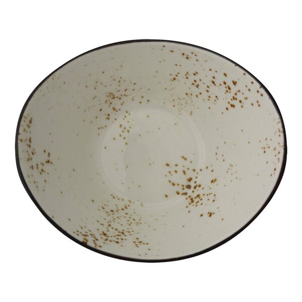 A white bowl with brown specks on it.