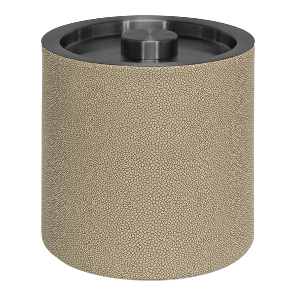 A round beige faux shagreen ice bucket with a round matte black lid.