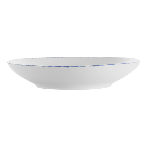 A white porcelain pasta bowl with blue sponged accents on the rim.