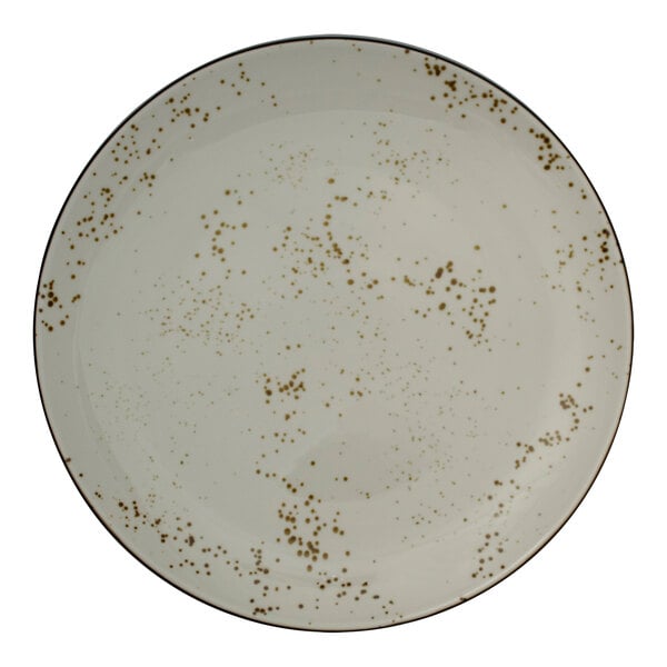 A white plate with brown speckled spots.