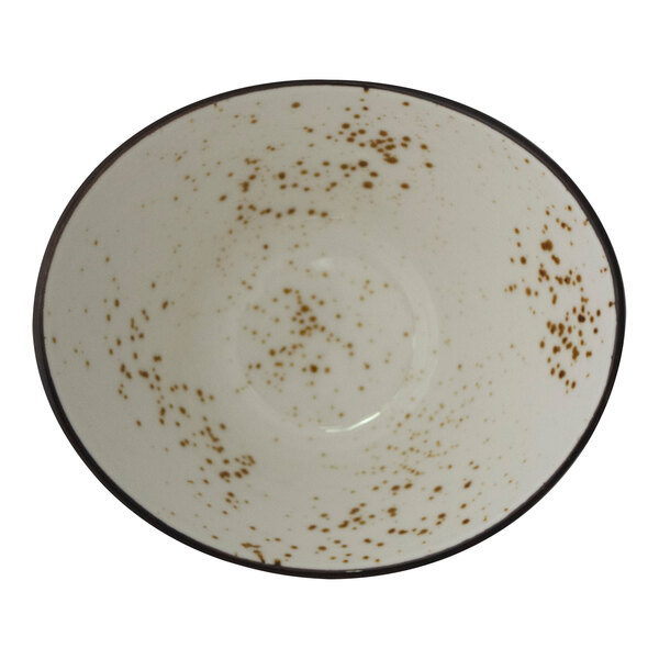 An International Tableware white stoneware oval fruit bowl with brown speckled spots.