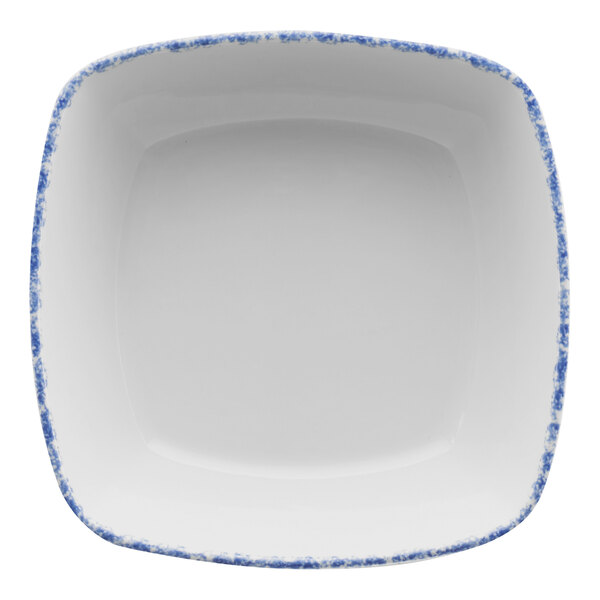 A white square porcelain bowl with blue sponged spots.