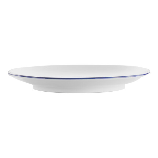 A white porcelain coupe plate with a blue rim.