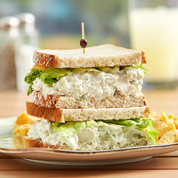 A sandwich with Don's Salads white meat chicken salad on a plate.