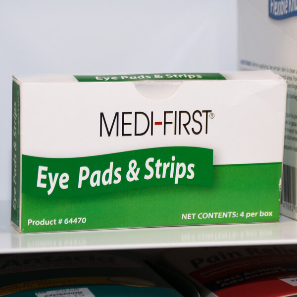 A close-up of a Medique box of 4 Med-First eye pads.