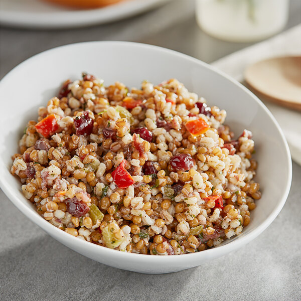 A white bowl of Don's Cranberry Grain Salad on a table.