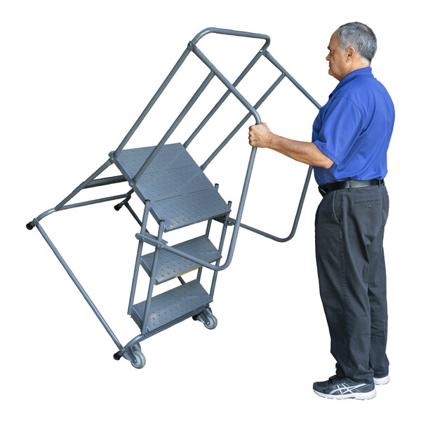 A man holding a Ballymore steel rolling safety ladder with handrails.