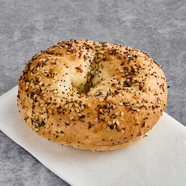 A Just Bagels pre-sliced everything bagel with seeds on it.
