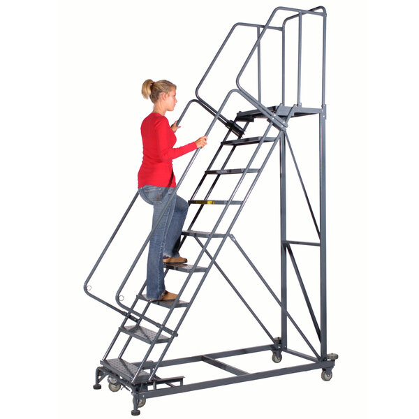 A woman climbing up a Ballymore Monster Line steel safety ladder with handrails.