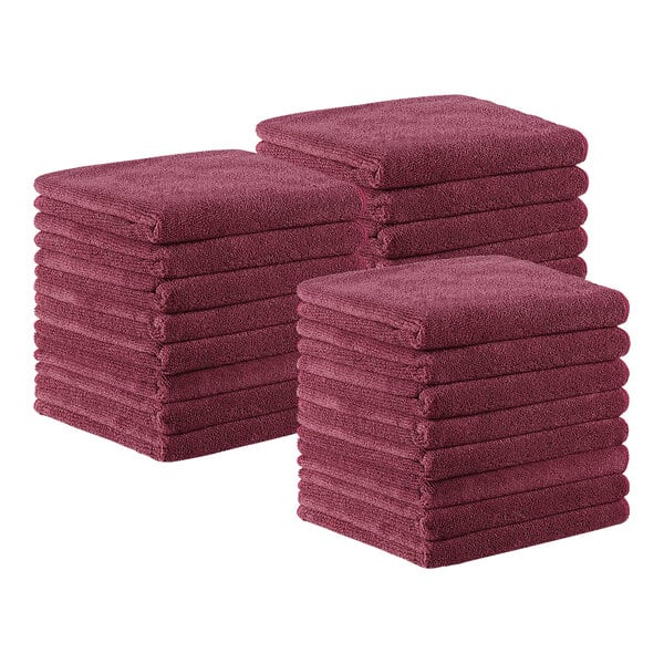 A stack of burgundy Monarch Brands microfiber hand towels.