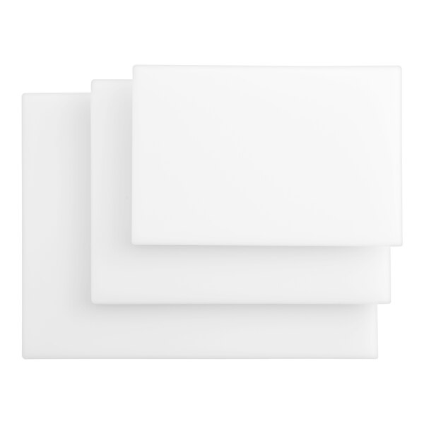 A stack of three white rectangular polyethylene cutting boards.