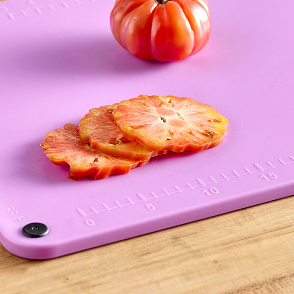 A purple Choice cutting board with tomato slices on it.