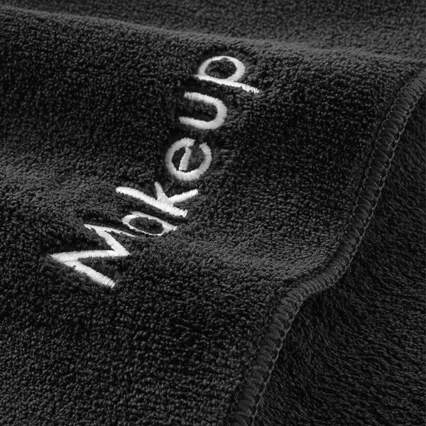 A black Monarch Brands makeup wash cloth with white text.