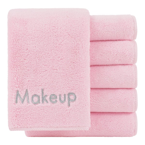 A stack of pink Monarch Brands makeup wash cloths with the word makeup on them.