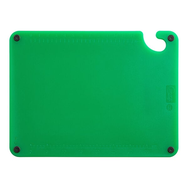 A green plastic cutting board with grips and rulers.