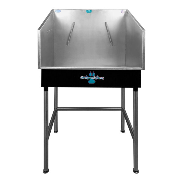 A black metal Groomer's Best bathing tub with a center drain.