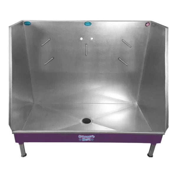 A silver and purple metal Groomer's Best walk-in bathing tub with a center drain.