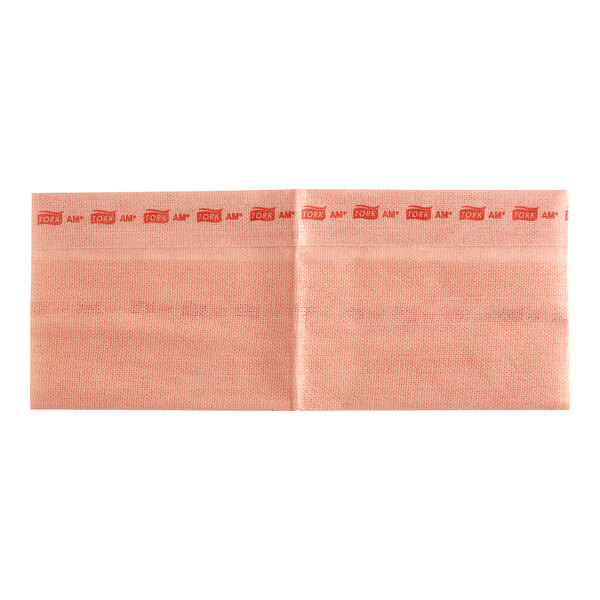 A pink paper bag with red writing on it.