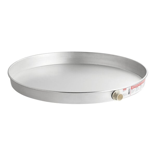 An aluminum round water heater pan with a white label.