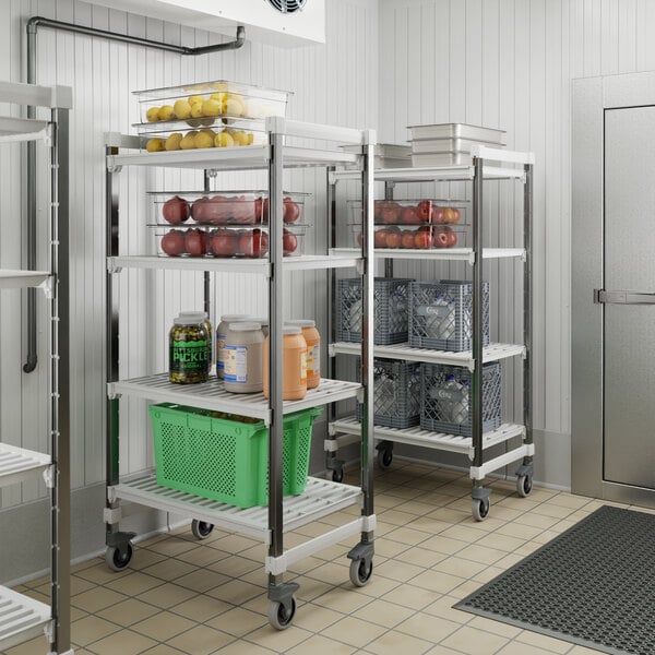 A Cambro Camshelving Elements mobile unit in a school kitchen filled with food.