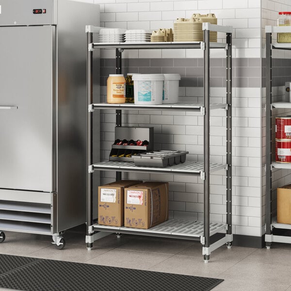 A Cambro Camshelving Elements metal shelving unit with food containers and boxes on the shelves.