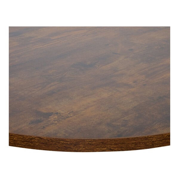 A BFM Seating Relic round walnut melamine table top with matching edge.