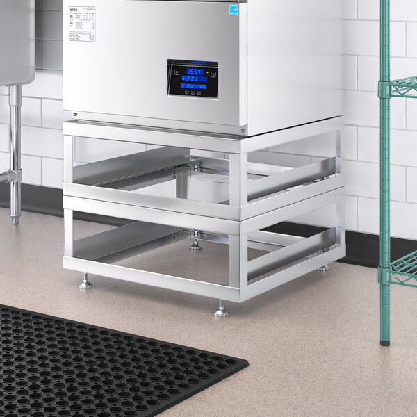 A set of two stainless steel stands for a Noble Warewashing undercounter dish machine.