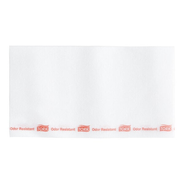 A white rectangular Tork paper with red text.