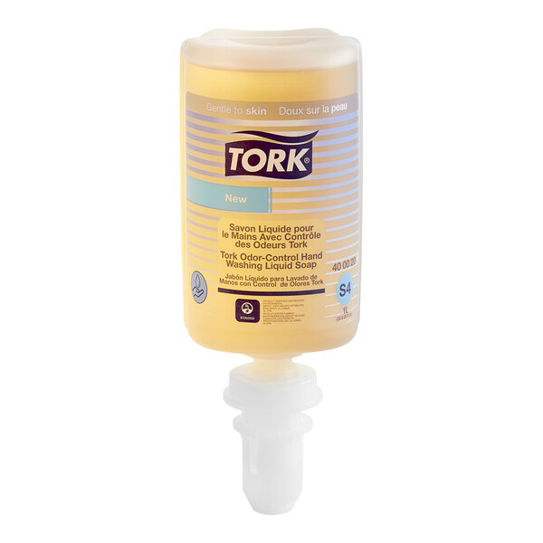 A close-up of Tork liquid hand soap with a white cap and label.