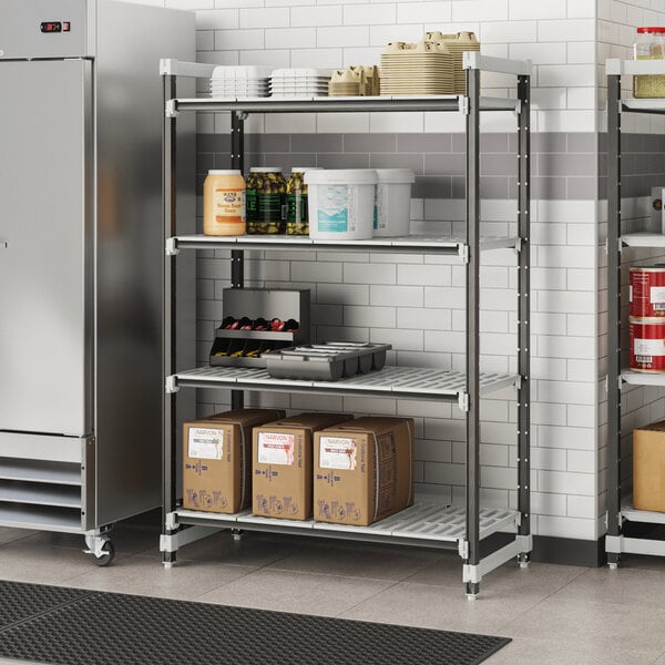 A Cambro metal shelving unit with brown boxes and food containers on a shelf.