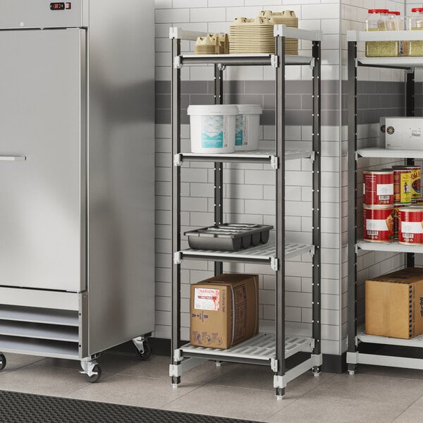 A Cambro Camshelving Elements starter unit in a school kitchen with containers on the shelves.