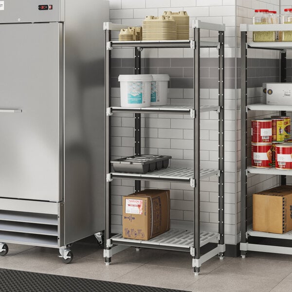 A Cambro Elements metal shelving unit with vented shelves holding containers.