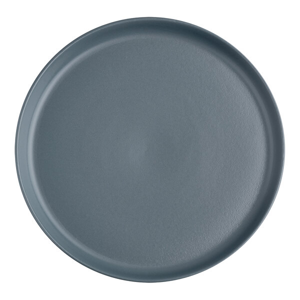 A grey round plate with a dark grey slate surface.