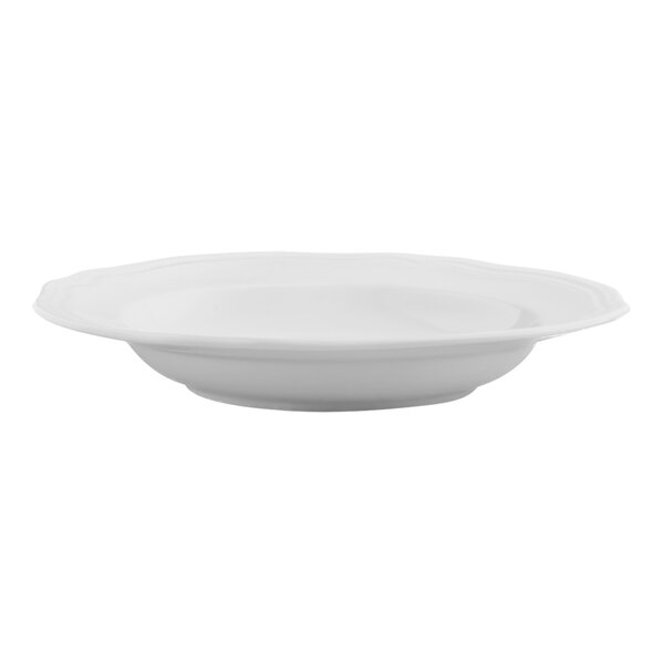 An Arcoroc white porcelain bowl with scalloped edges on a white background.