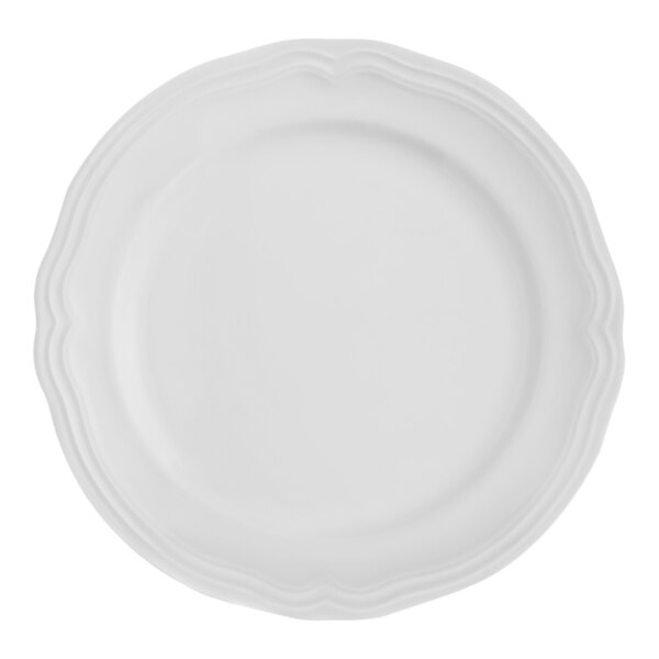 An Arcoroc Athena white porcelain plate with a scalloped edge.