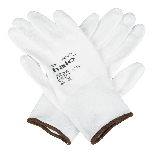 A pair of white Cordova Halo HPPE and synthetic fiber gloves with a white polyurethane palm coating and brown trim, size 2X.