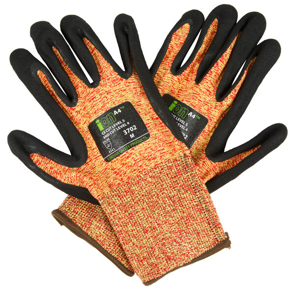 A pair of Cordova heavy duty work gloves with black and orange trim and a black sandy nitrile palm.