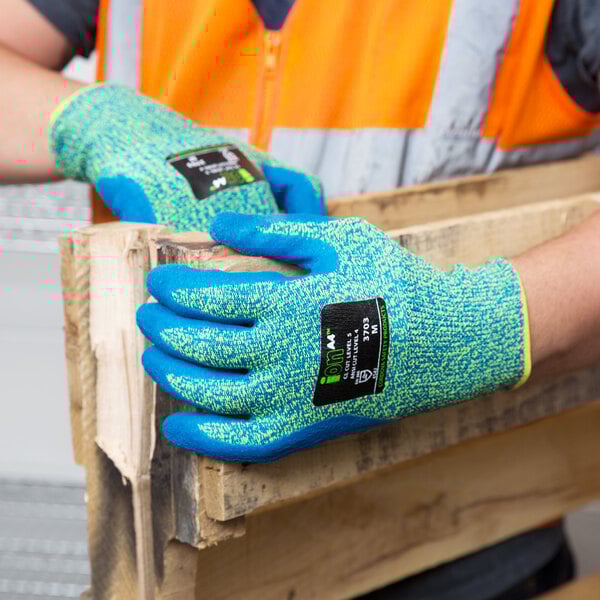 A person wearing blue Cordova iON gloves with a crinkle latex palm coating on their hands.