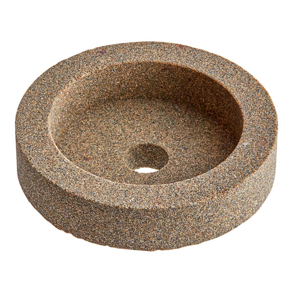 A circular sharpening stone with a hole in the center.