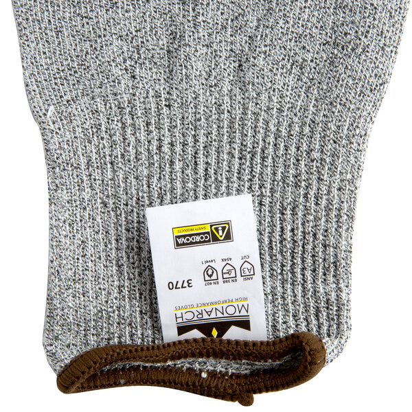 A pair of extra small grey Cordova Monarch gloves with a white label.
