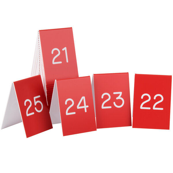 A group of red Cal-Mil table tents with white numbers