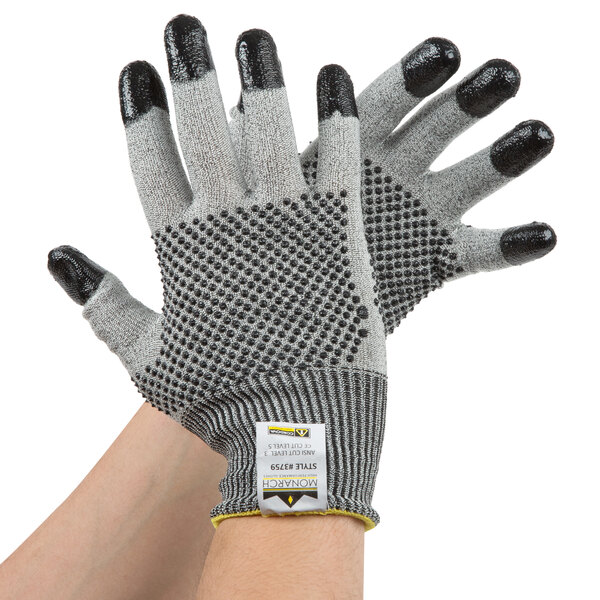 A pair of Cordova Monarch small work gloves with two-sided black nitrile dots.