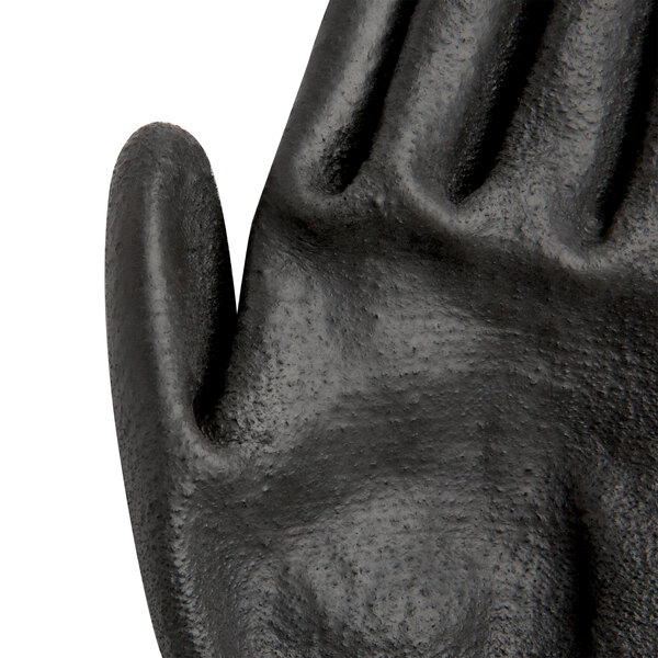 A close-up of a Cordova Monarch black and green glove.
