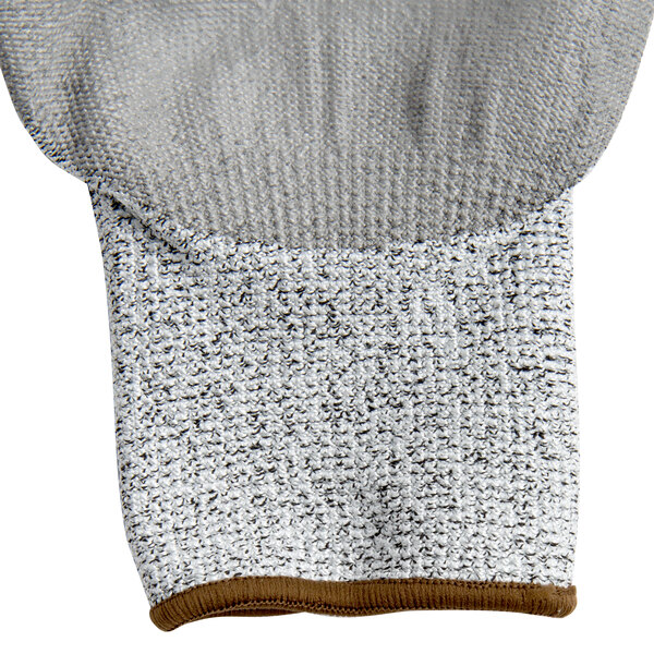 A close up of a Cordova Caliber warehouse glove with gray palm coating.