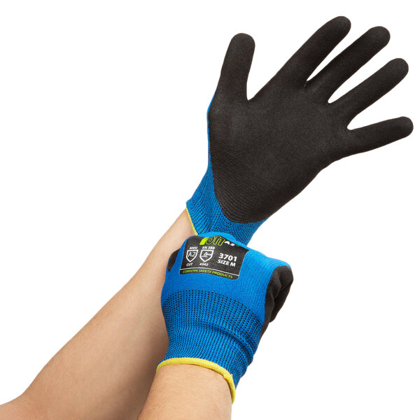 A pair of hands wearing Cordova iON blue and yellow warehouse gloves with black palm coating.