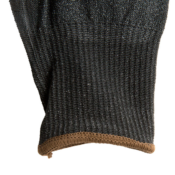 A close up of a Cordova Monarch black glove with brown trim on the palm.