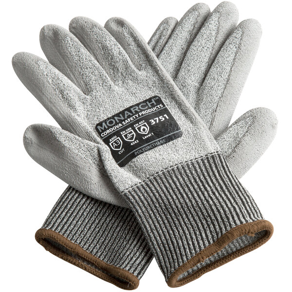 A pair of small gray Cordova Monarch gloves with gray polyurethane palms and a label.
